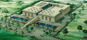 Aerial view of a contemporary architectural building with pools and landscaped surroundings.