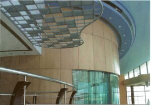 Elegant modern interior architecture with curved wooden and glass elements.